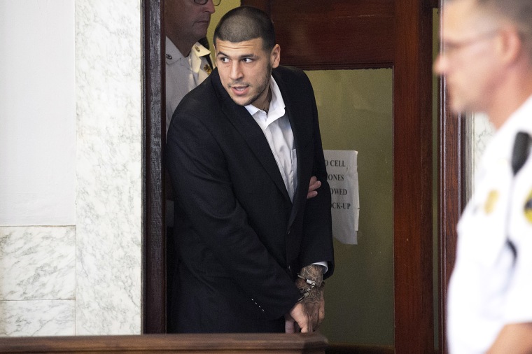 Aaron Hernandez entering the court room in cuffs.