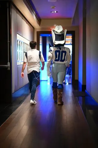 Corey Wernecke Eric Aaberg and Dallas Cowboys mascot Rowdy walk side by side
