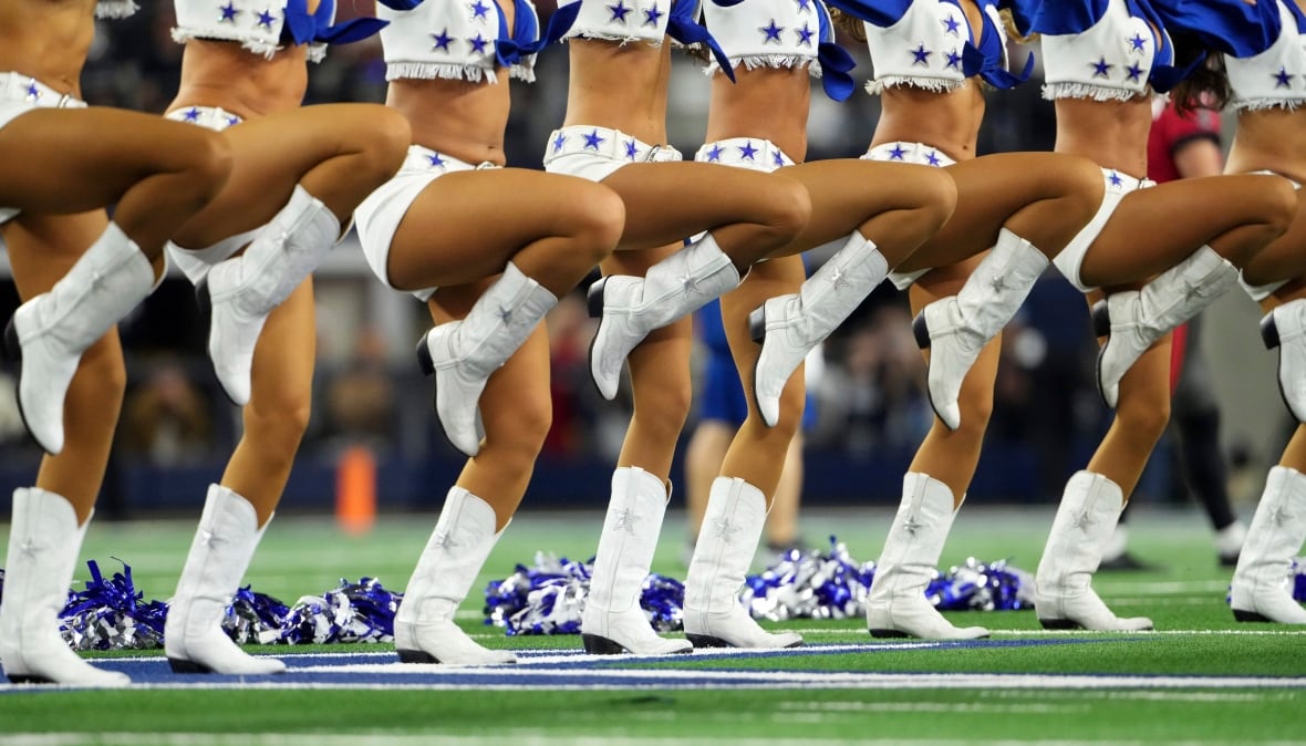 A line of cheerleaders, visible from the waist down