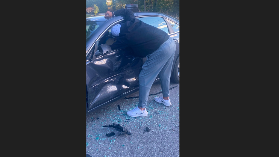 This photo, taken by an assistant coach in October, shows Coach Tony Lotti helping a football player who’d just been in a T-bone wreck leaving the school.