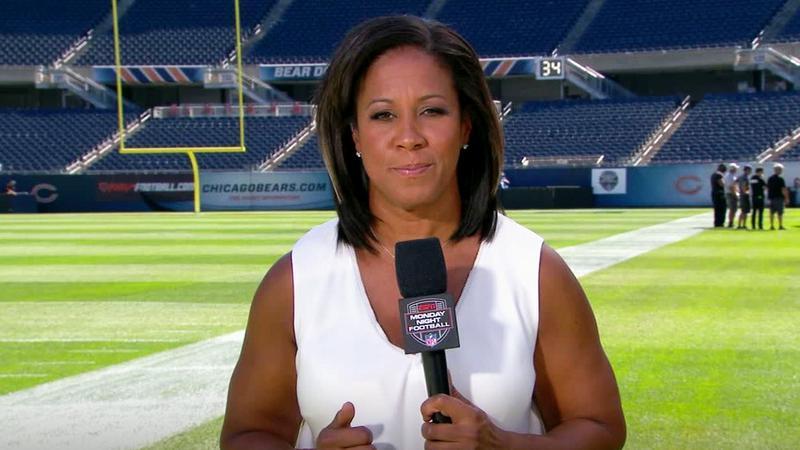 Lisa Salters on a football field with a microphone in her hand