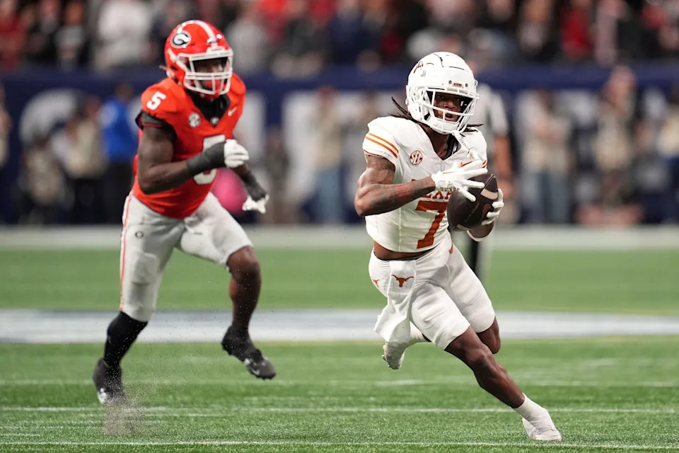 Dec 7, 2024; Atlanta, GA, USA; Texas Longhorns wide receiver Isaiah Bond (7) makes a catch past Georgia Bulldogs linebacker Raylen Wilson (5) during the first half in the 2024 SEC Championship game at Mercedes-Benz Stadium. Mandatory Credit: Dale Zanine-Imagn Images