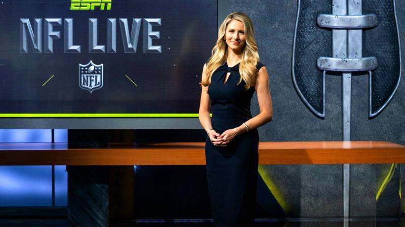 Laura Rutledge on an ESPN set in a dark blue dress
