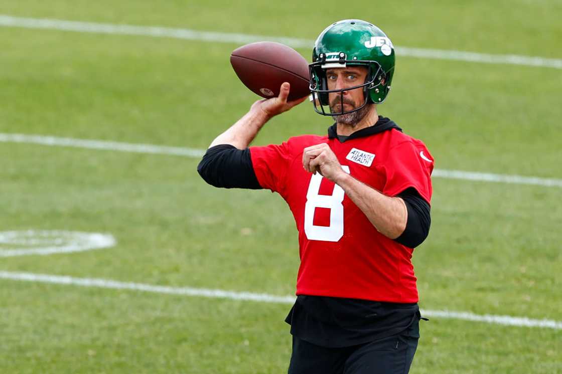 Quarterback Aaron Rodgers #8 of the New York Jets attempts to pass the ball on the field Quarterback Aaron Rodgers #8 of the New York Jets attempts to pass the ball on the field