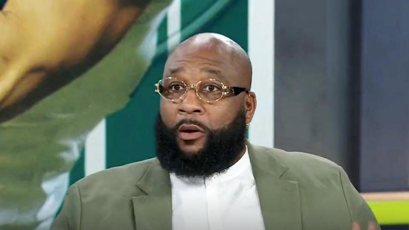 Marcus Spears wearing glasses on an ESPN set