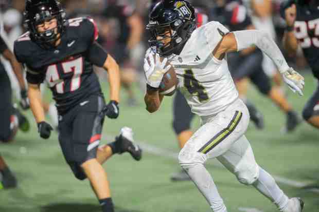 Servite's Jorden Wells, (#4), carries the ball and is pursued by Centennial's Felix Munoz, (#47), during a game at Centennial High School in Corona, Friday, Aug. 22, 2025. (Photo by John Valenzuela/Contributing Photographer)