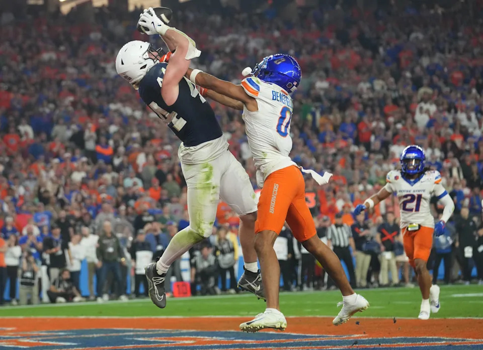 Dec 31, 2024; Glendale, AZ, US; Penn State Nittany Lions tight end Tyler Warren (44) catches a touchdown pass over Boise State Broncos safety Ty Benefield (0) during their Vrbo Fiesta Bowl matchup at State Farm Stadium.