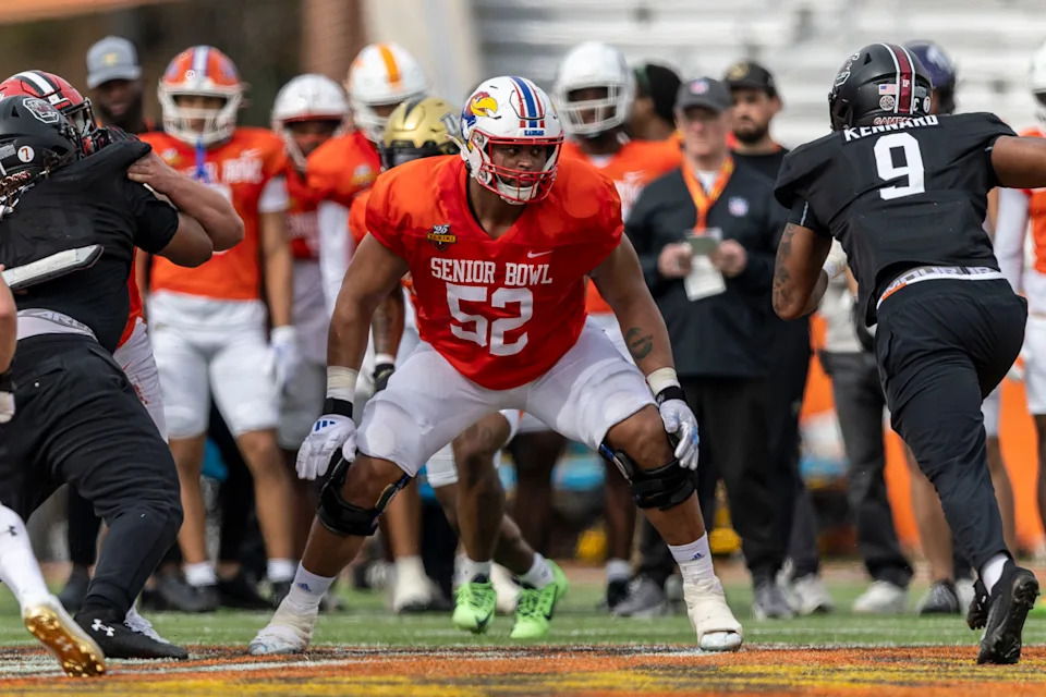 Jan 28, 2025; Mobile, AL, USA; American team offensive lineman Logan Brown of Kansas (52) sets up to block during Senior Bowl practice for the American team at Hancock Whitney Stadium. Mandatory Credit: Vasha Hunt-Imagn Images