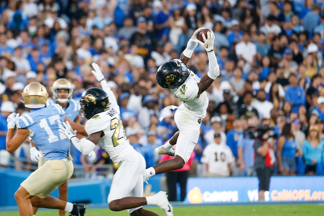 Colorado wide receiver Travis Hunter #12 catches an interception intended for UCLA wide receiver Logan Loya #17 during an NCAA college football game, Oct. 28, 2023, in Pasadena, Calif.