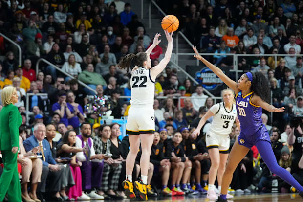 Caitlin Clark shoots a jumper over Angel Reese