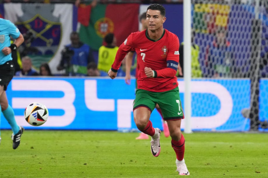 cristiano ronaldo at the uefa euro tournament dribbling a soccer ball upfield