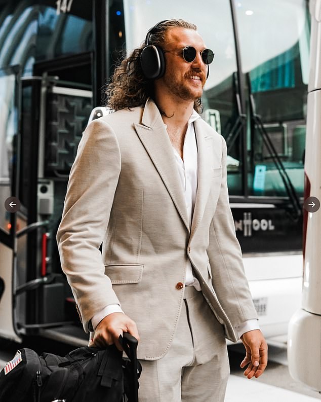 TJ Hockenson opted for a smart look, wearing a suit jacket and trousers as he got off the bus