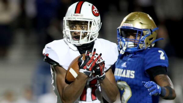 North Gwinnett wide receiver Josh Downs (11) catches a pass against McEachern defensive back Dacari Collins (2) in the first half during the Class AAAAAAA quarterfinals Nov. 29, 2019, at McEachern High School in Powder Springs.