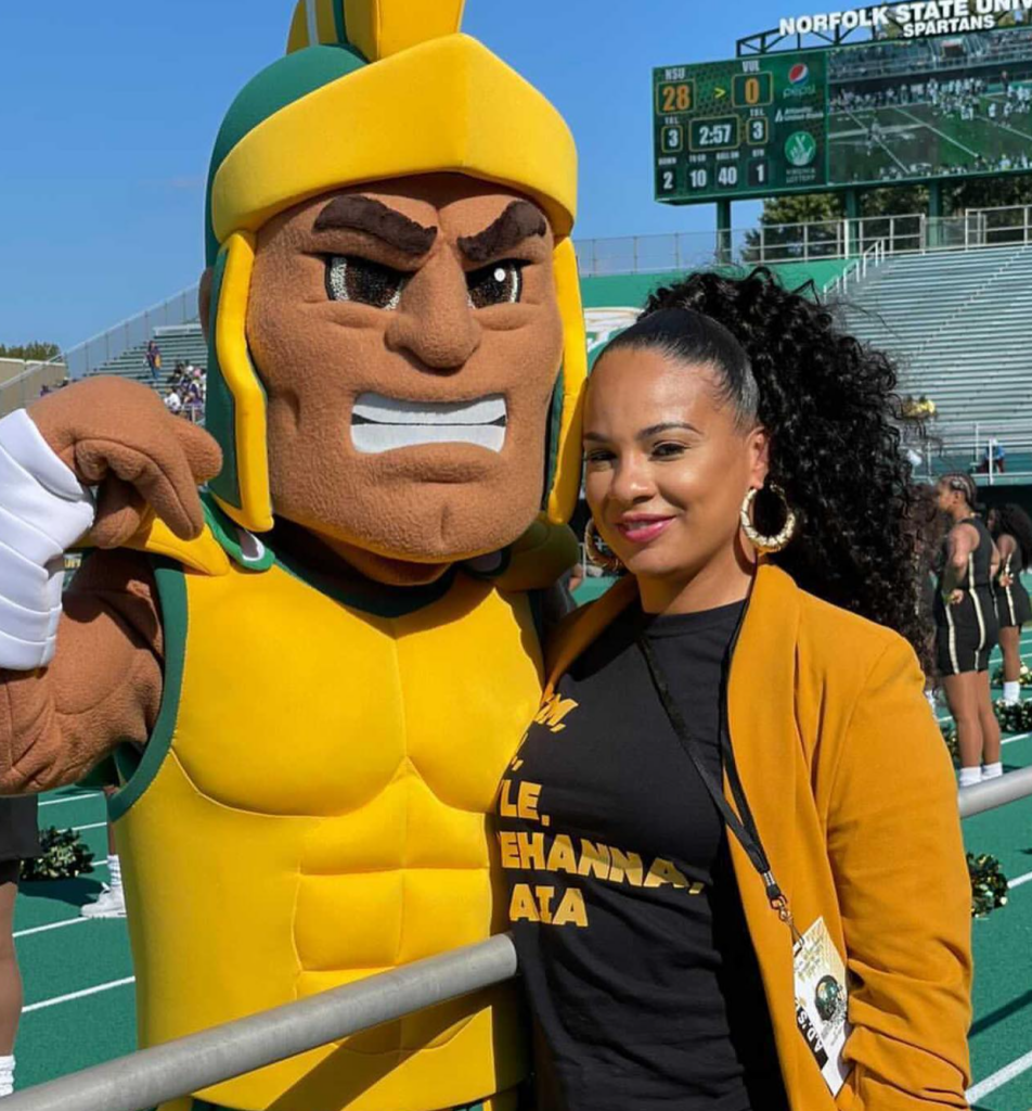 A woman and a football mascot