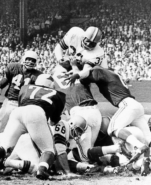 Browns running back Jim Brown hurdles in for a touchdown from the 1-yard line in the first quarter against the St. Louis Cardinals on Sept. 20, 1964, in Cleveland.