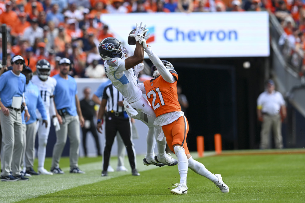 Elic Ayomanor leaps up in the Breakout Wide Receivers 2025 article to snag the ball over a defender.