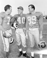 The Los Angeles Rams high-powered passing combination, probably football's best, gets together at Redlands, Calif., as the NFL titleholders began drills July 23, 1952. From left: quarterback Bob Waterfield and ends Elroy Hirsch and Tom Fears.