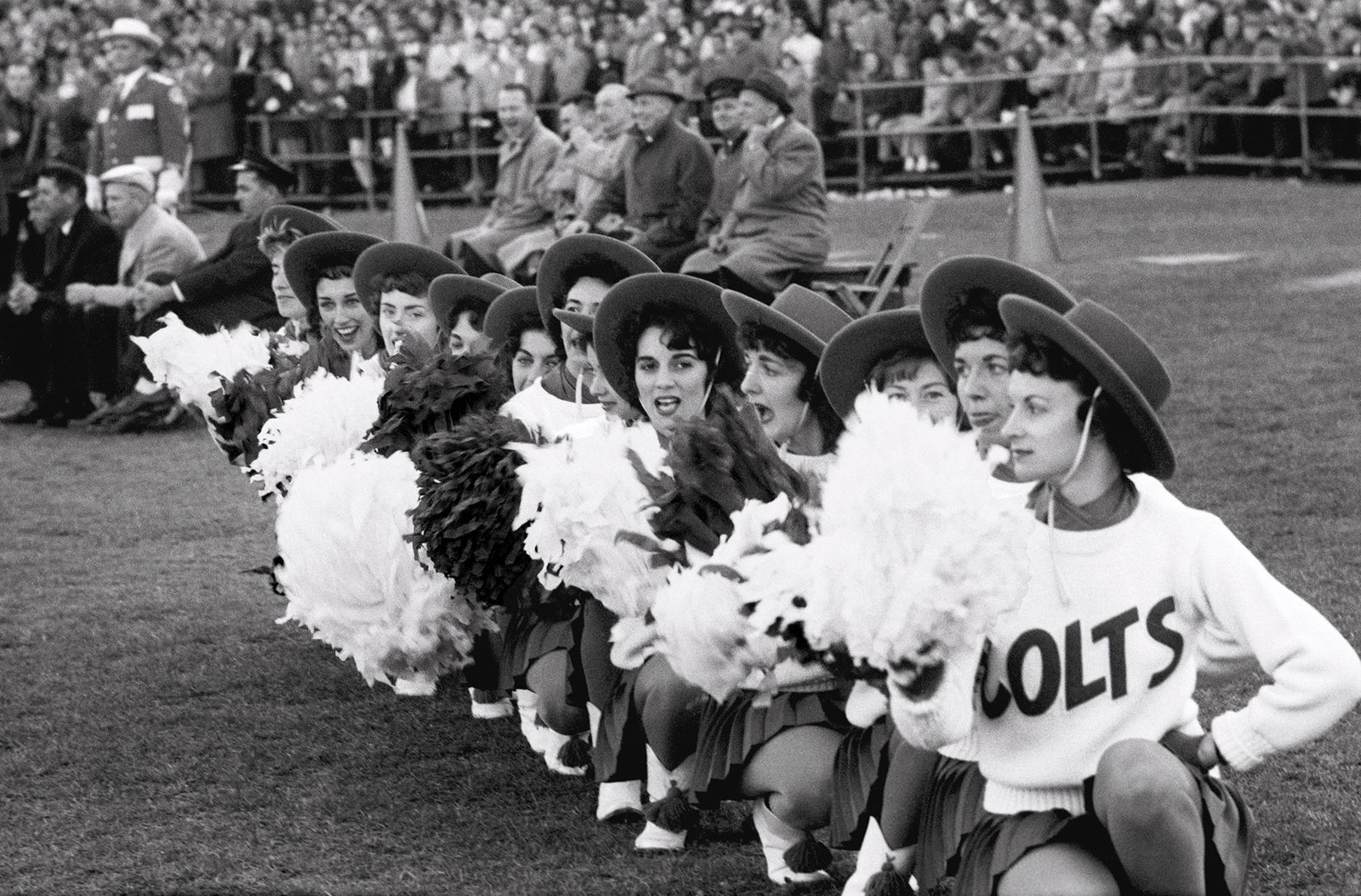 Colts cheerleaders wearing hats and displaying Pom Poms