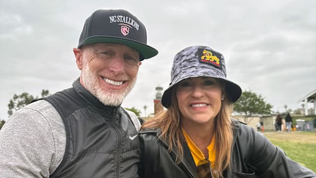 Former NFL quarterback Jeff Garcia, watches the action with Dr. Jen Welter.