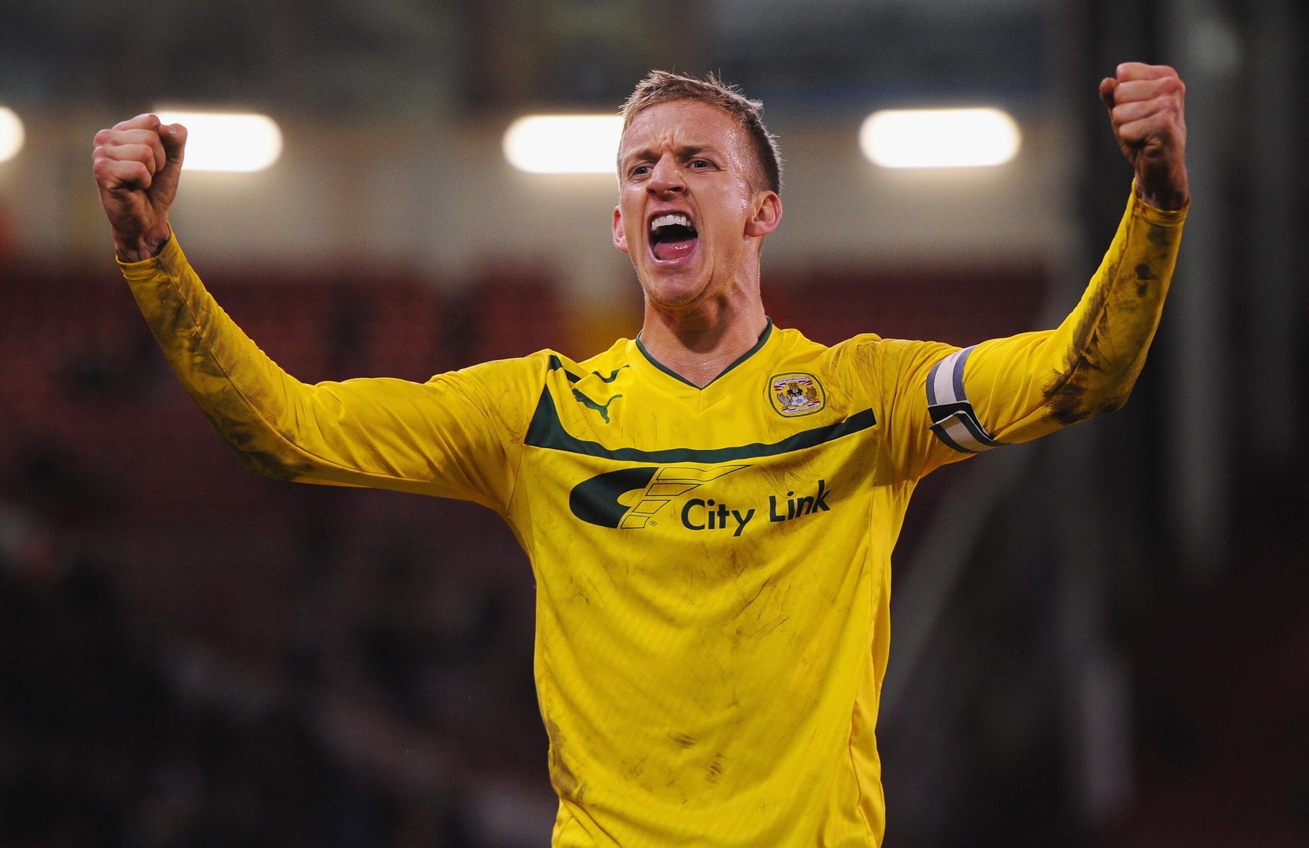 Carl Baker holds his arms aloft in celebration during his days as a Coventry City player