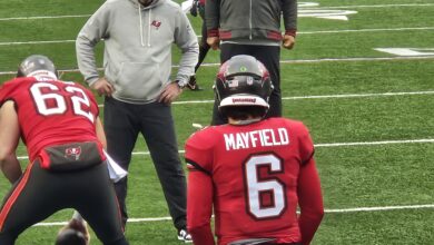 Archival full-frame photograph of Baker Mayfield and Graham Barton warming up before a 2025 Buccaneers game