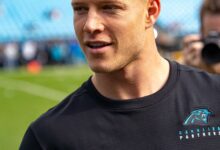 Archival full-frame photograph of Christian McCaffrey warming up before a Carolina Panthers game in 2019