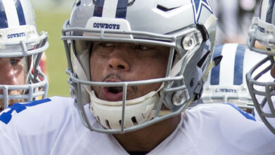Archival full-frame photograph of Dallas Cowboys quarterback Dak Prescott in a team huddle during a 2016 game