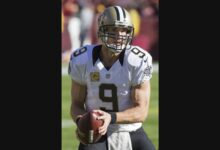 Archival photograph of Drew Brees holding a football during a 2015 New Orleans Saints game