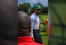 Jalen Hurts walking onto the field at Eagles training camp in July 2025