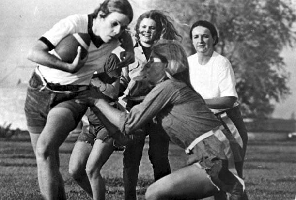 Archival full-frame 1972 photograph of a women’s recreational flag football game